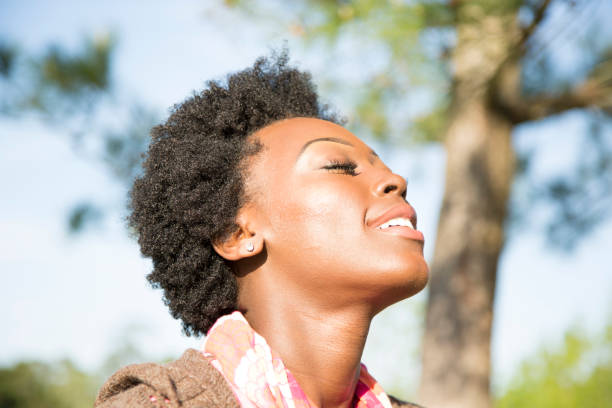 istock Woman enjoys feeling the sun on her face. 853329556