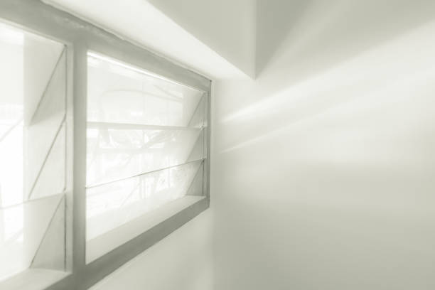 istock Abstract light from window on cement white wall in B&W tone 853337444