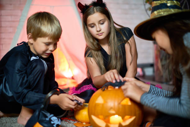 istock Cute friends playing with Halloween toys 853342816