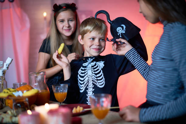 istock Cheerful kids having fun at Halloween party 853343002