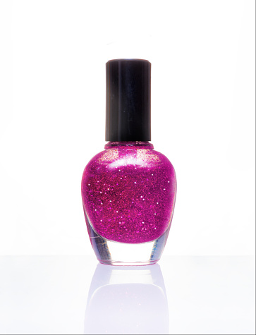 Single curvy Bottle of Glitter pink nail polish on white background