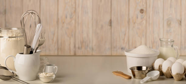 istock Kitchen utensils and tools for homemade baking on a light wooden background. 853351012