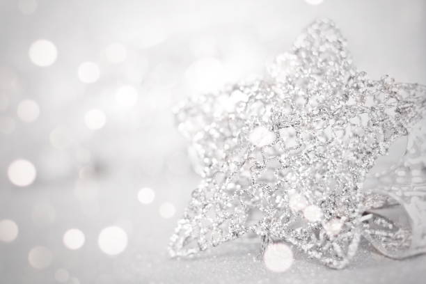 istock Shiny silver star ornaments on bright abstract background bokeh 853355920