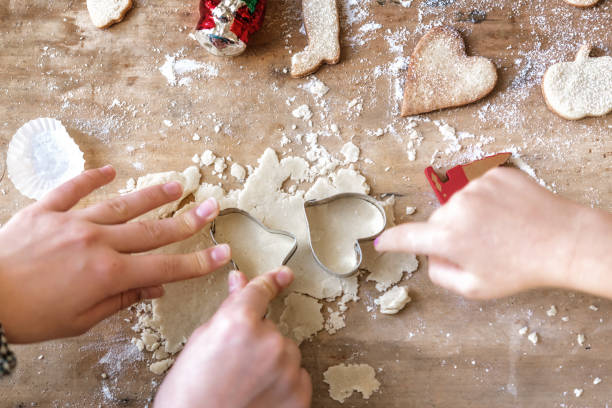 istock children baking christmas cookies on wooden table 853364632