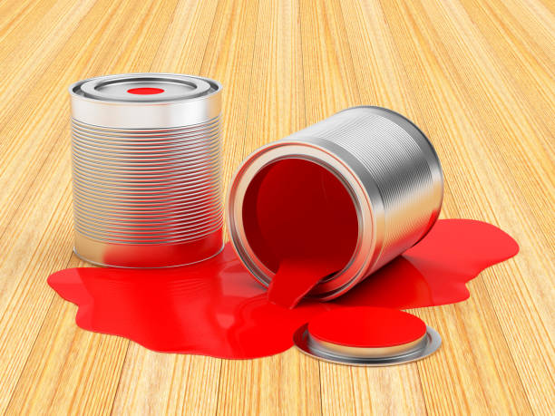 istock Cans spilled red paint on wooden background 853365522