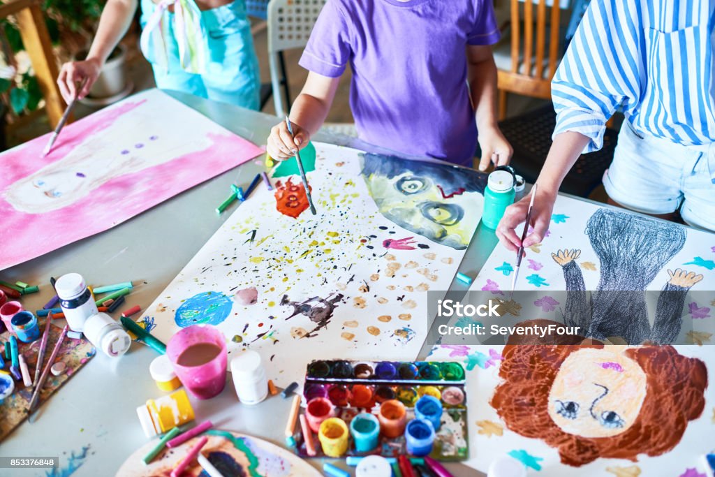 Hands of Children Painting in Art Class High angle of unrecognizable children painting pictures with watercolors working together in art studio Child Stock Photo
