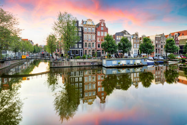 istock Amsterdam Canal houses at sunset reflections, Netherlands 853401426