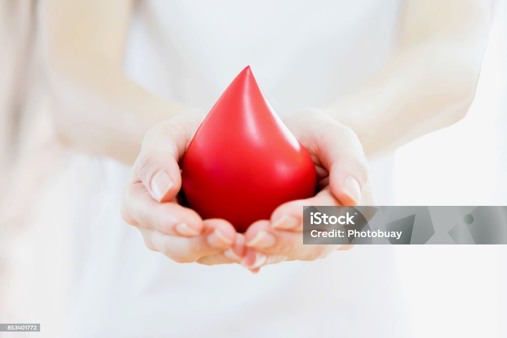 Hands holding a red blood Blood Stock Photo