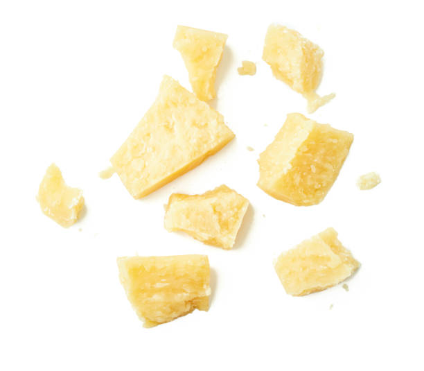 istock Parmesan cheese pieces on white background. Italian cheese slices. Top view. 853402176