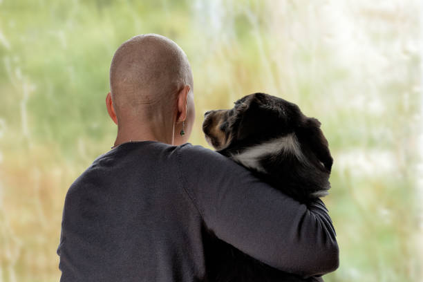 Cancer patient conforted by her dog.