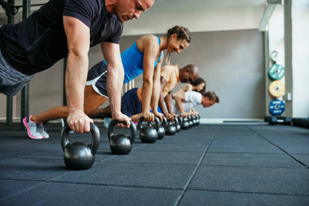 istock People doing pushups together in a health club class 853407238
