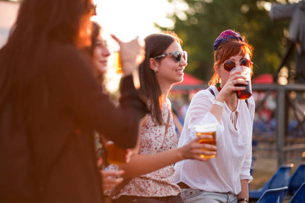 Tasting Beer In Beer Festival Group Of Charming And Cheerful Young Women Tasting Beer At Summer Festival woman drinking beer stock pictures, royalty-free photos & images