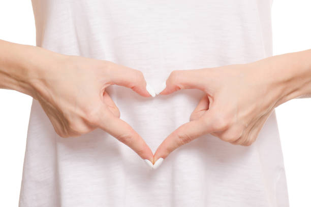 istock Female hands on a belly heart 853423322