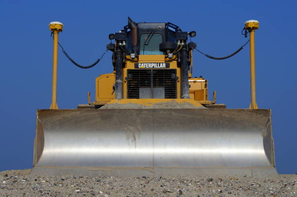 Track drive gear, bulldozer sprocket mechanism, large yellow construction machine with bolts, heavy industry, detail