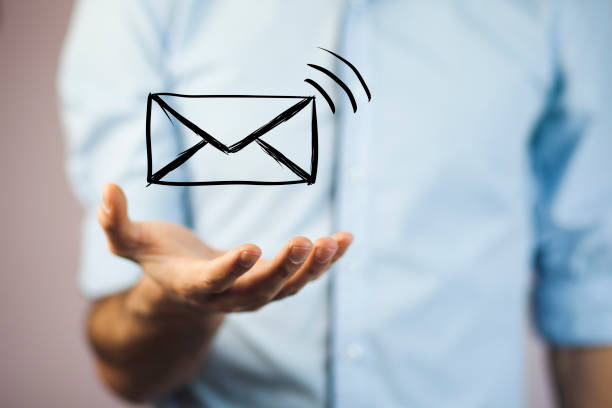 istock man holds a virtual postal envelope, concept of emai 853441956