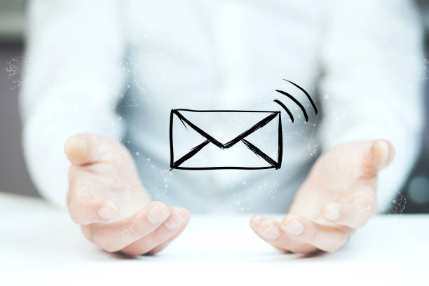 istock man holds a virtual postal envelope, concept of emai 853442024