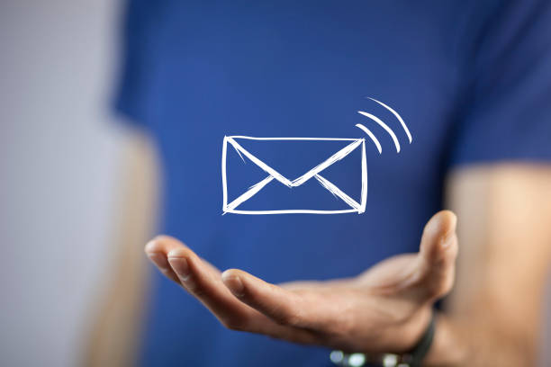 istock man holds a virtual postal envelope, concept of emai 853442056