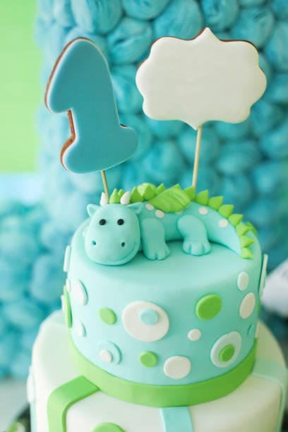 istock Adorable first birthday cake with dragon. 853447226