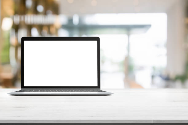 istock Wood table top with blank screen laptop on blurred abstract background interior view inside reception hotel or modern hallway for background 853468764