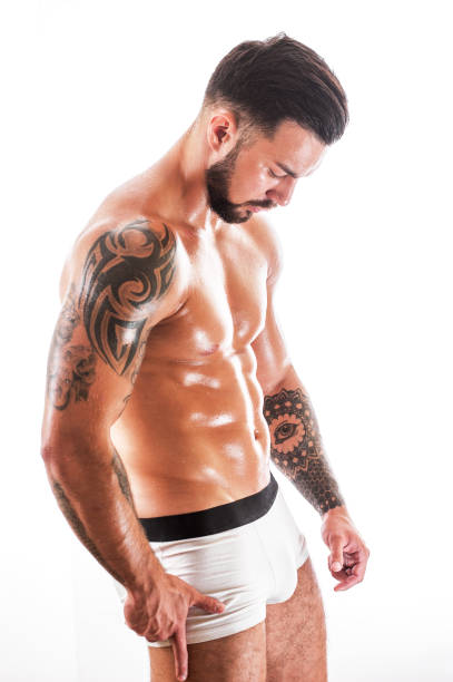 istock Athletic sexy man with tattooed torso in underwear 853487276