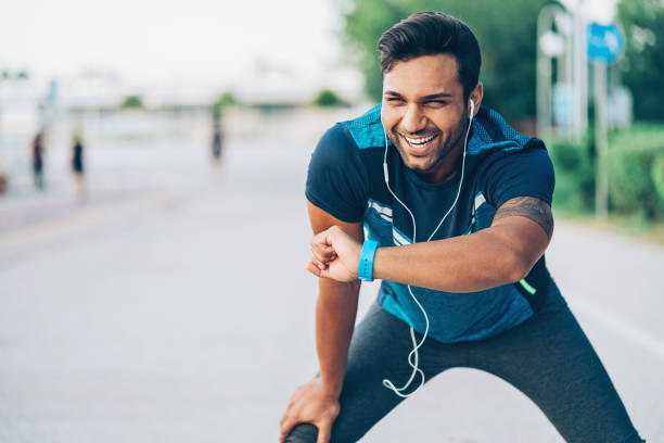 istock Smiling young sportsman checking his smart watch 853494072