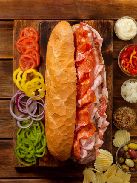 sotto sandwich per feste caricato su una pagnotta francese - sandwich turkey cold cuts snack foto e immagini stock