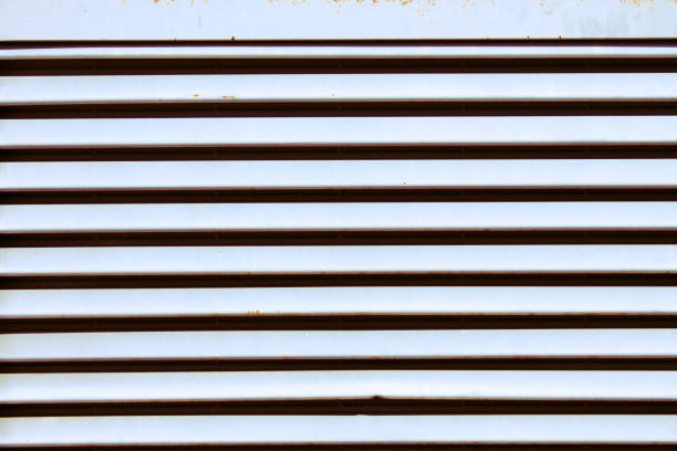 White roller shutter with dark horizontal strips White and black metallic grate background texture with dark horizontal strips shadows silverstone stock pictures, royalty-free photos & images