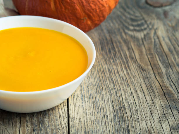 istock white plate with pumpkin orange soup on wooden aged background with empty space for your text 853497514