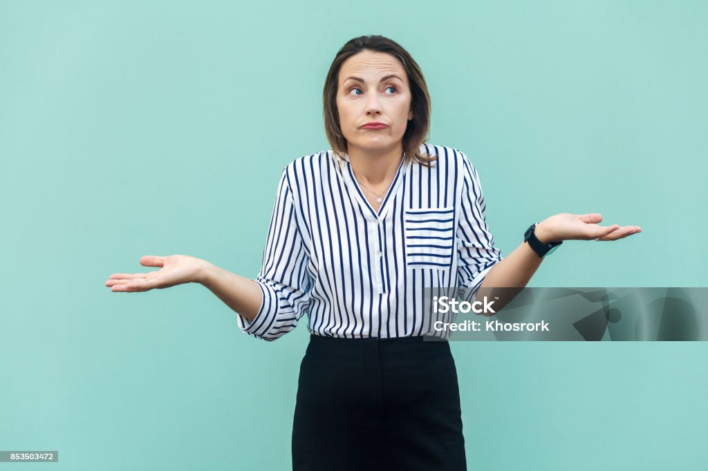 I Dont Know. Handsome blonde businesswoman with looking at camera and confused. Gesturing Stock Photo
