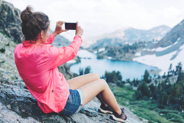 istock Brave woman taking photo in mountains 853513702