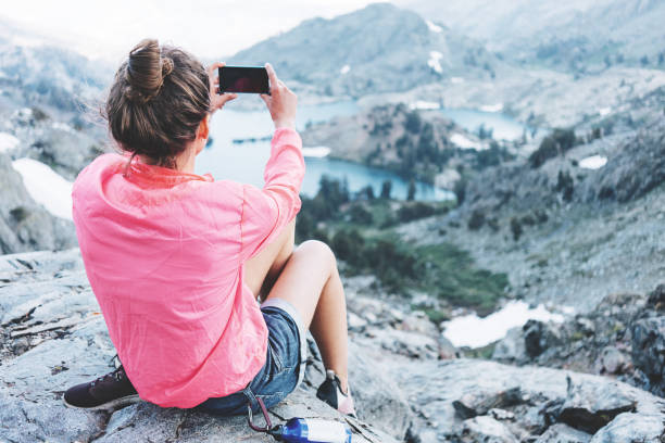 istock Brave woman taking photo in mountains 853517380
