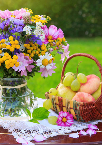 istock Bouquet colorful wild flowers and fruit basket 853521548