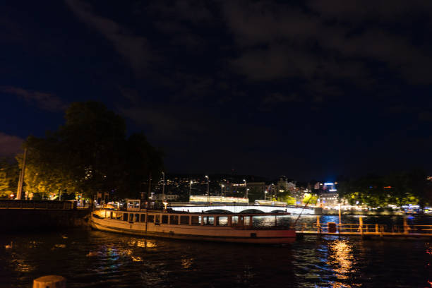 istock zurich city night view from lake side with water reflections and cloudy sky 853521842