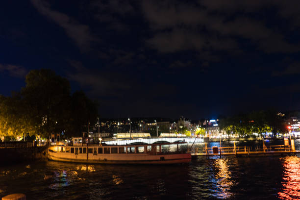 istock zurich city night view from lake side with water reflections and cloudy sky 853521906