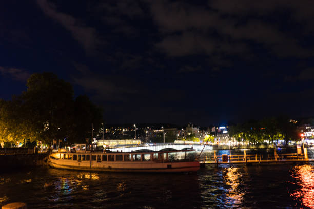 istock zurich city night view from lake side with water reflections and cloudy sky 853521992