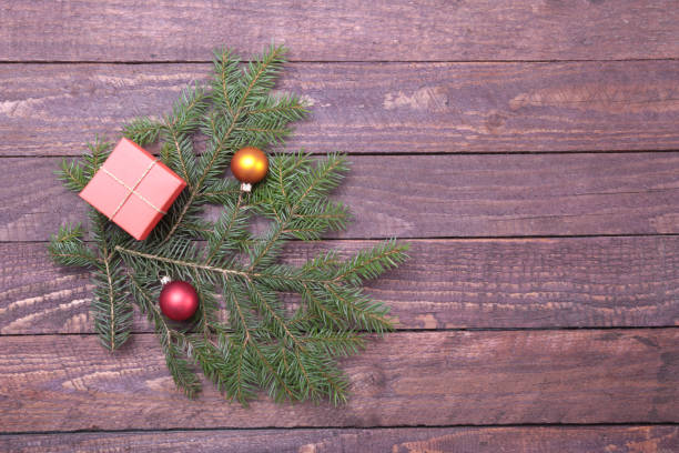 istock Christmas decorations with gift boxes, tree and balls on wooden background. 853522116