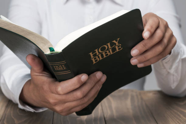 istock Woman hands and Holy Bible 853532330