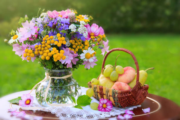 istock Bouquet colorful wild flowers and fruit basket 853532380