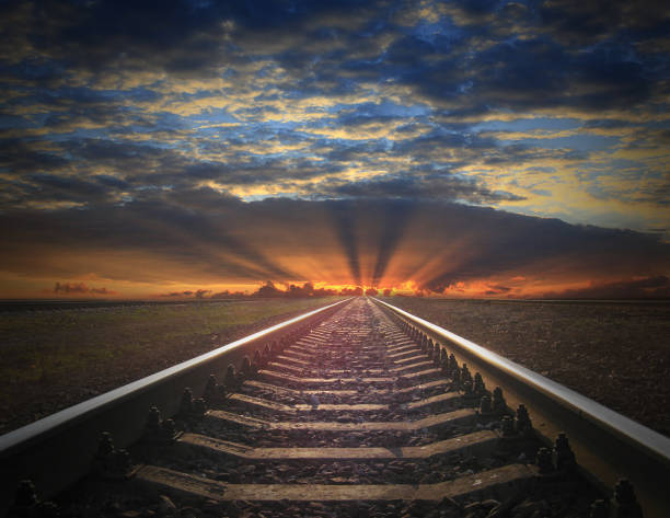 istock rails going away into the fiery red sunset 853536716