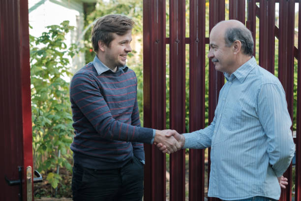 istock two farmers shaking hands and takling to each other 853542180