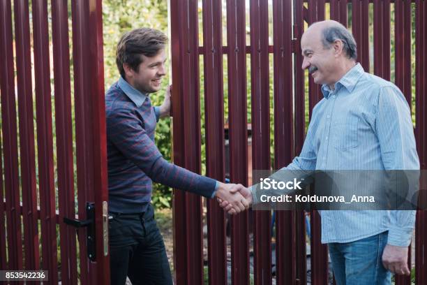 Two Farmers Shaking Hands And Takling To Each Other Stock Photo - Download Image Now