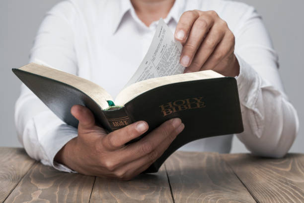 istock Woman hands and Holy Bible 853560698