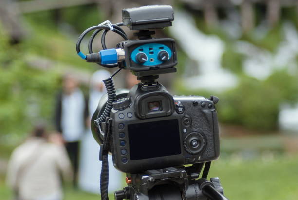 istock Modern camera with mic on tripod recording nature 853568850