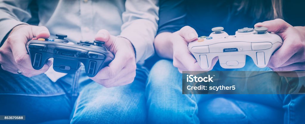 Gaming game play video on tv or monitor. Gamer concept. gaming game play fun gamer gamepad guy pad player girl controller online video closeup sitting focus console person concept - stock image Video Game Stock Photo