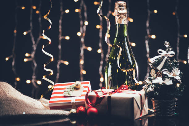 istock bottle of champagne and christmas tree 853572532