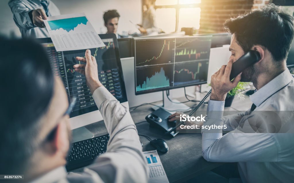 Business team deal on a stock exchange. Stock traders concept. Business team investment trading do this deal on a stock exchange. People working in the office. Stock Market and Exchange Stock Photo