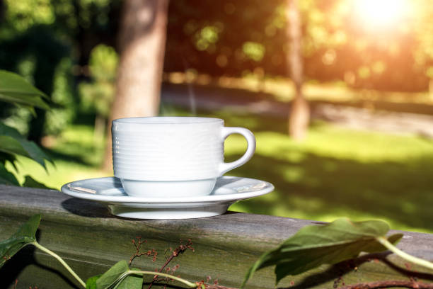 istock Coffee cup  on wooden background outdoors 853580468