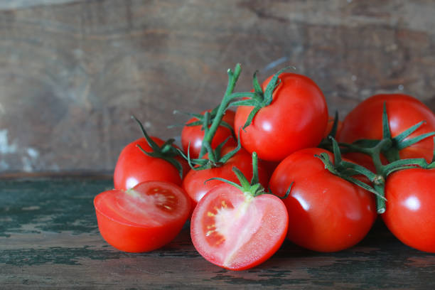 istock branch of tomatoes on wooden background 853588708