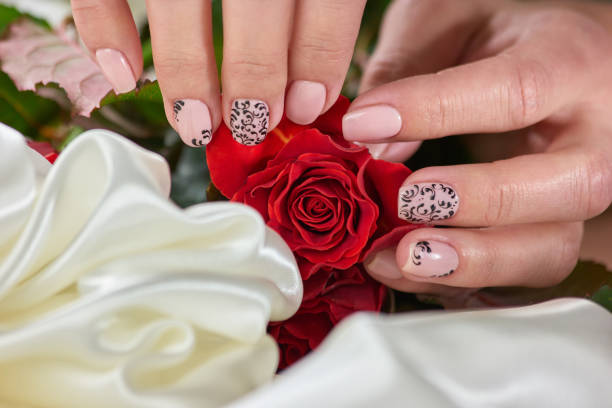 istock Female manicure hands, roses, silk. 853588872