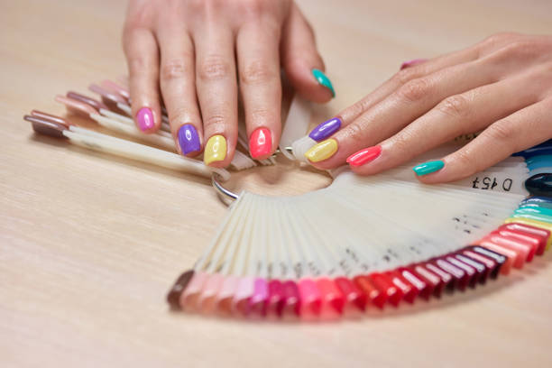 istock Multicolored summer manicure on female hands. 853588962